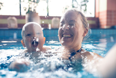 mom and baby in pool