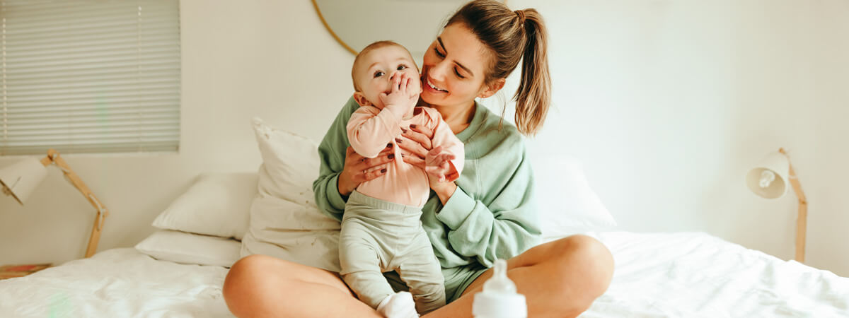 Mom and little baby on bed
