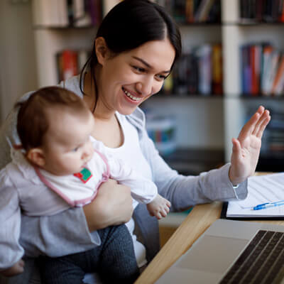 Woman and baby talking to someone in a video chat