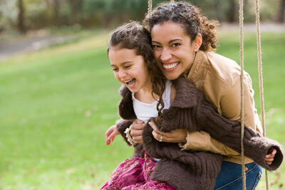 Mother and daughter on swing