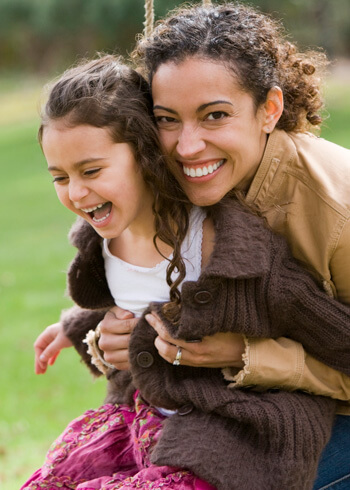 Mom and daughter playing on swing