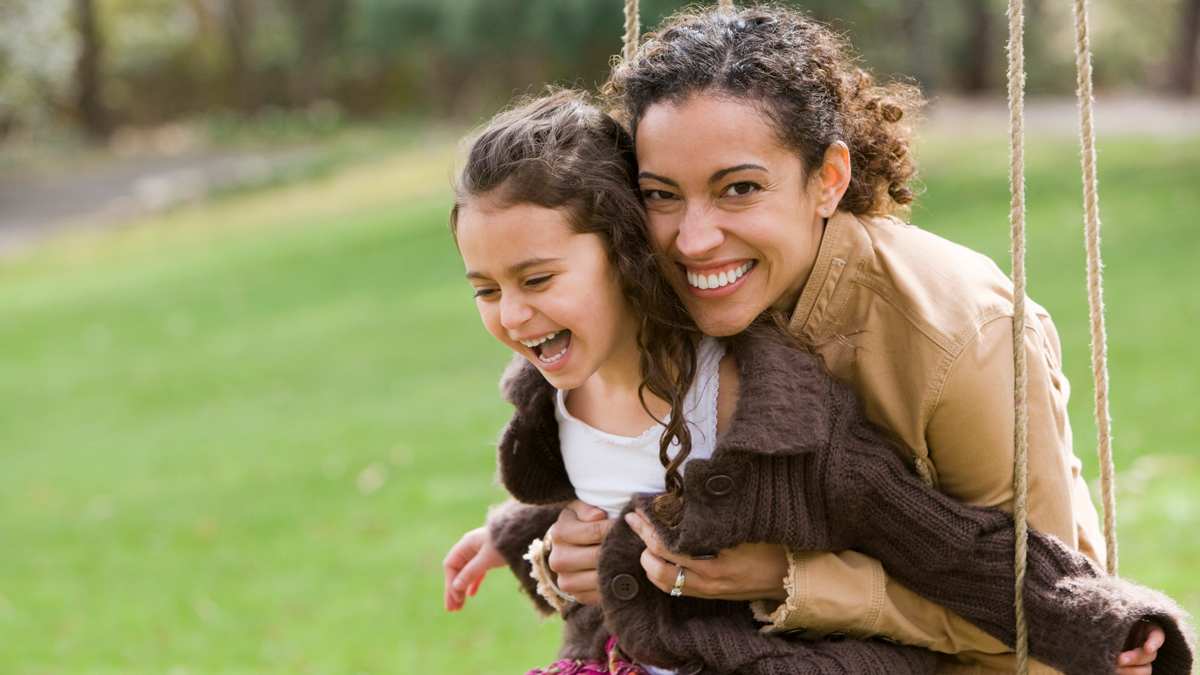 Woman and daughter on swing