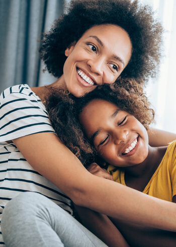 mom and young daughter hugging