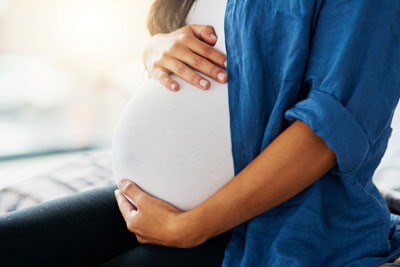 Woman holding pregnant belly