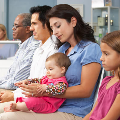 mom holding baby in waiting room