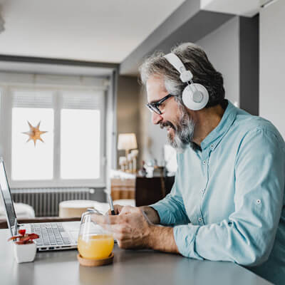 Man listening to music on his headphones and smiling