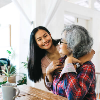 woman smiling and huging mom