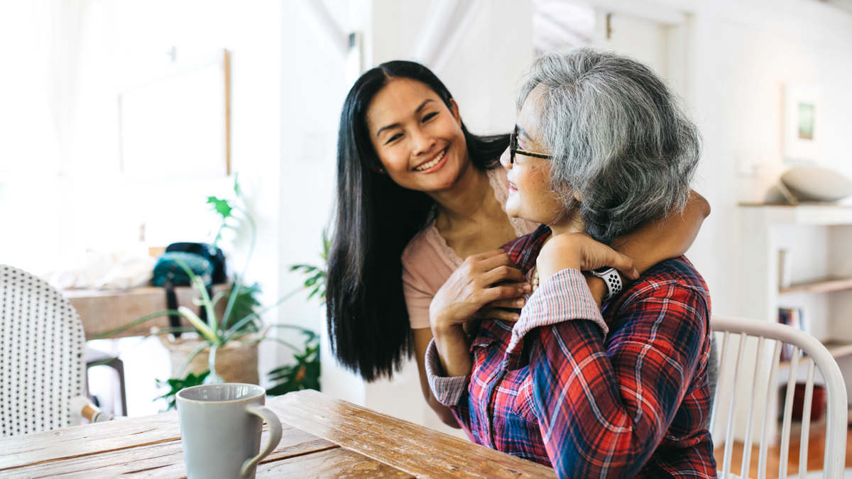 Middle aged woman and elderly woman laughing together