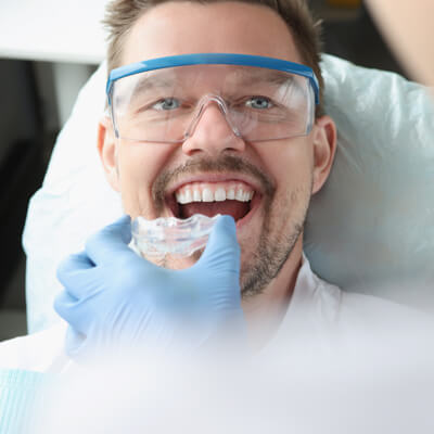 man being fitted for mouthguard