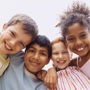 Four children hugging and smiling