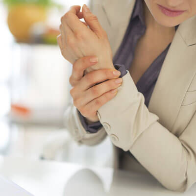 woman holding wrist in pain