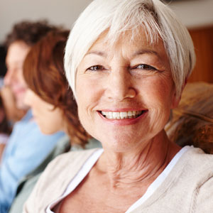 older woman smiling sitting on couch