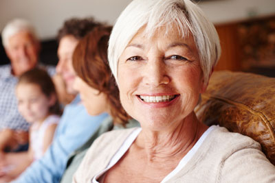 older woman on couch with family