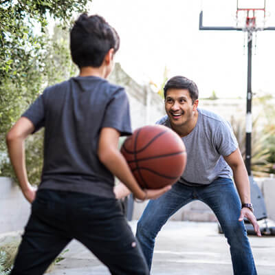 Man and boy playing basketball