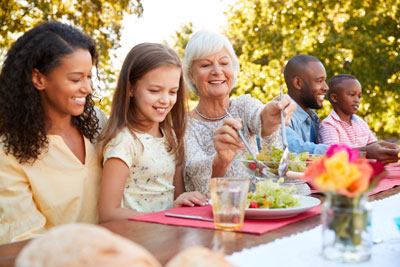 Multigeneration family eating together