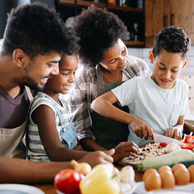 parents and kids prepare a meal