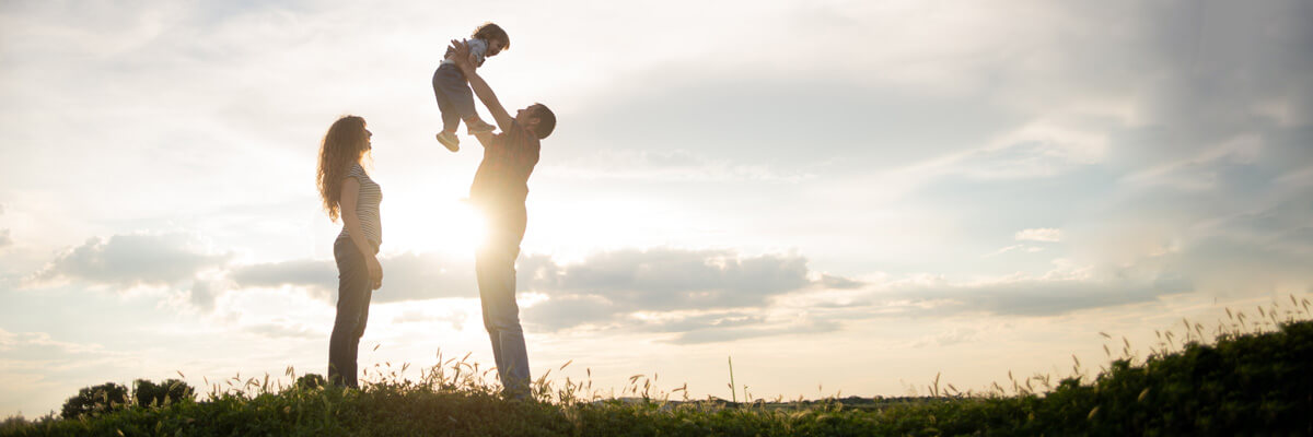 Parents lifting toddler in the air