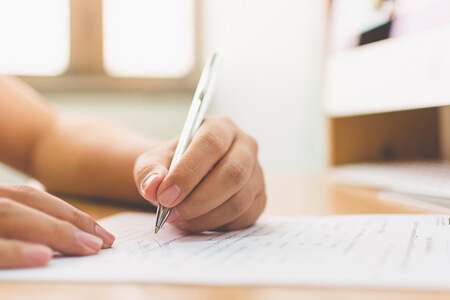 Person filling in paperwork