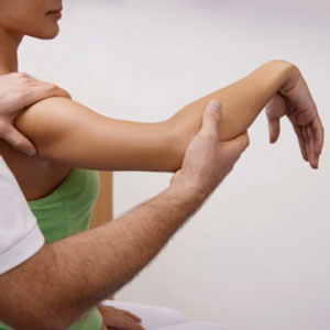 Chiropractor examining elbow