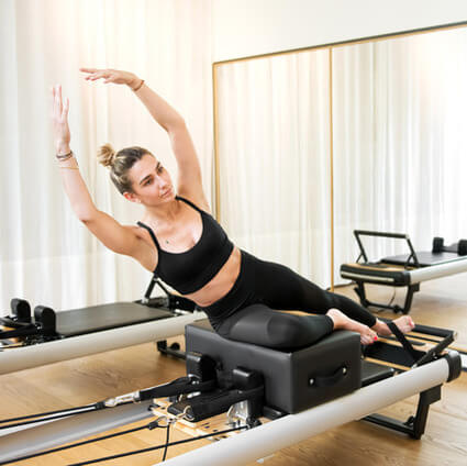 woman doing reformer pilates