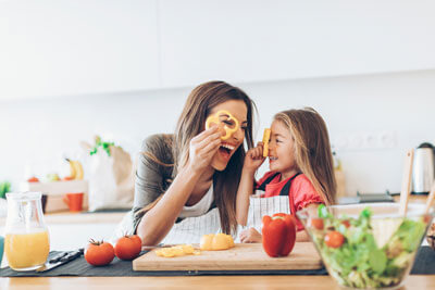 Mom and daughter making salad