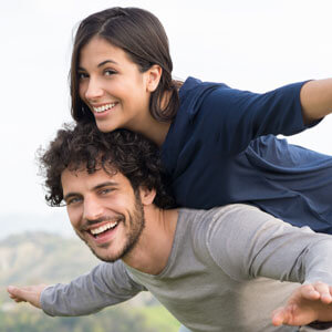 playful young couple smiling