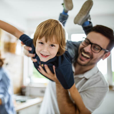 Father and son playing airplane