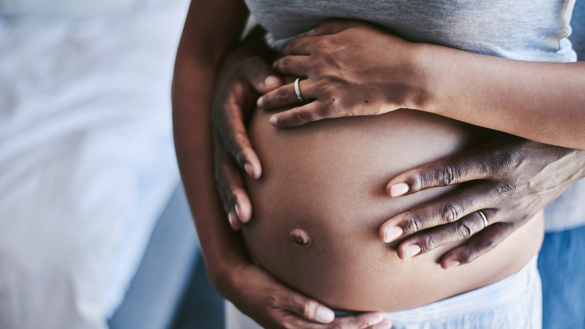 Hands around pregnant belly