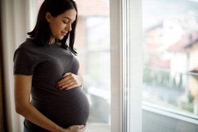 Pregnant woman holding belly