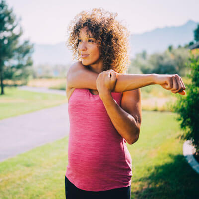 pregnant mom stretching outside