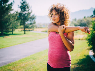 Pregnant mom stretching outside