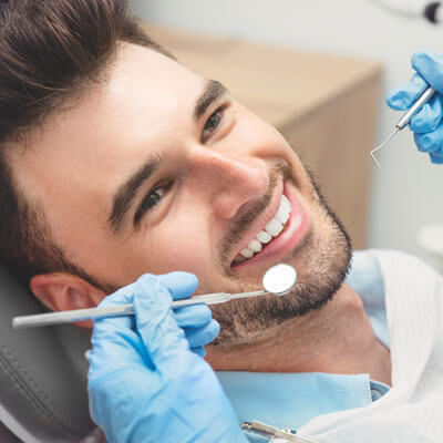 Man having his teeth inspected