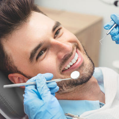 Man's teeth being cleaned