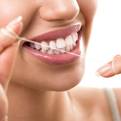 Woman flossing her teeth