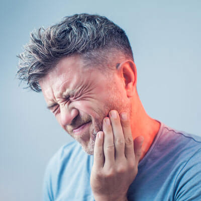 Man with severe tooth ache