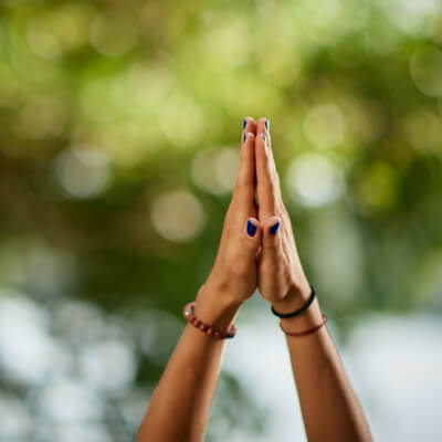 Hands raised in the air in a yoga pose