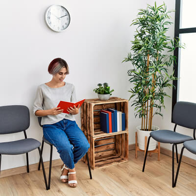 smiling person sitting in waiting area