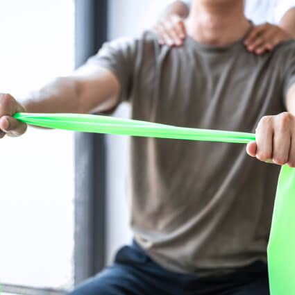 person using resistance band during physiotherapy