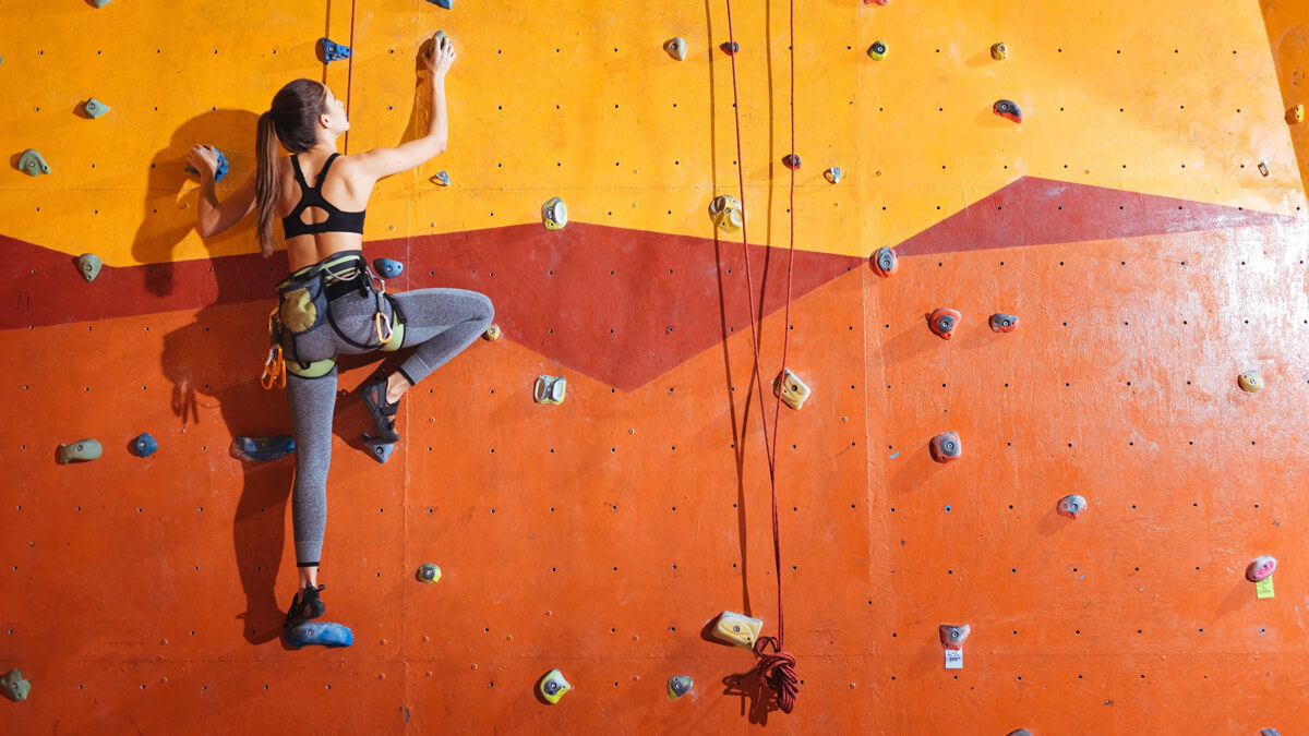 Rock climber on orange wall