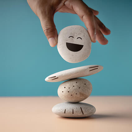 balancing rocks with smiley face