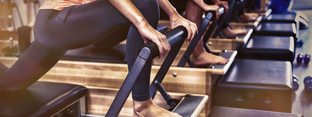 row of reformer pilates machines