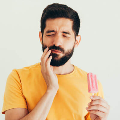 man with tooth pain popsicle
