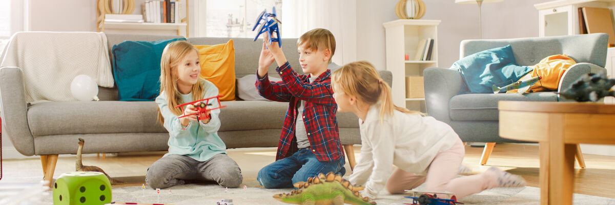 Three children playing with toys