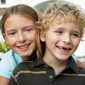 Young girl hugging her brother