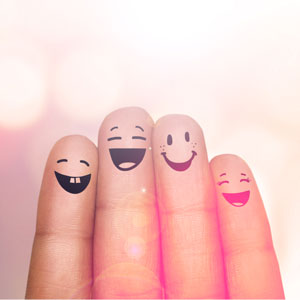 Fingers with smiling faces drawn on. 