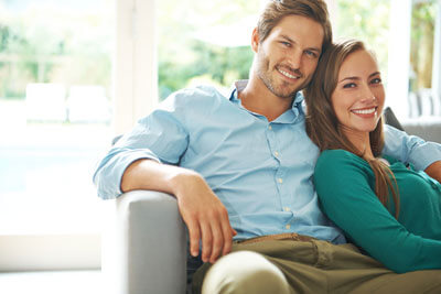 Man and woman sitting on couch