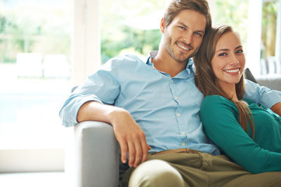 happy couple sitting on the couch