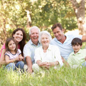 Multi-generational family sitting on the grass