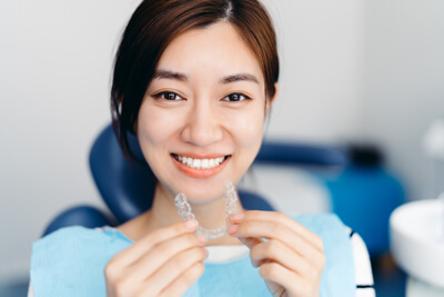 Woman holding clear aligner