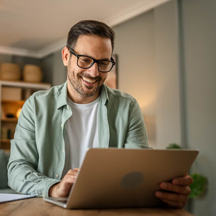 Smiling male using laptop 